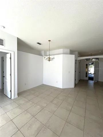 a view of a kitchen with furniture and an empty room