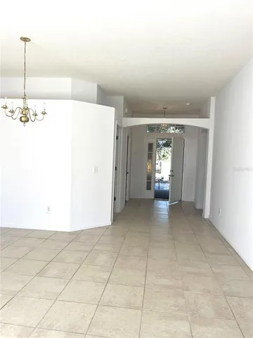 a view of a livingroom with an empty space and a window
