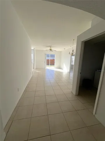 an empty room with a ceiling fan and a ceiling fan