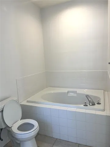 a bathroom with a sink toilet a mirror and shower