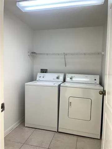 a view of a house with backyard and wooden fence