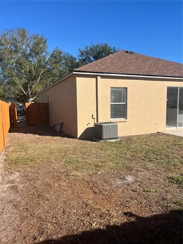 a view of a backyard with wooden fence