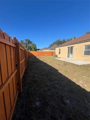 a view of a house with backyard and a garden