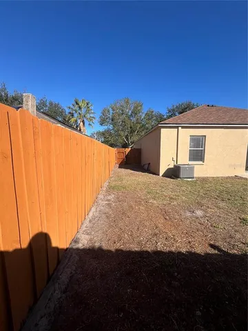 a view of walk in closet with window and red gate