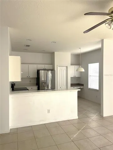a kitchen with granite countertop a refrigerator and a stove