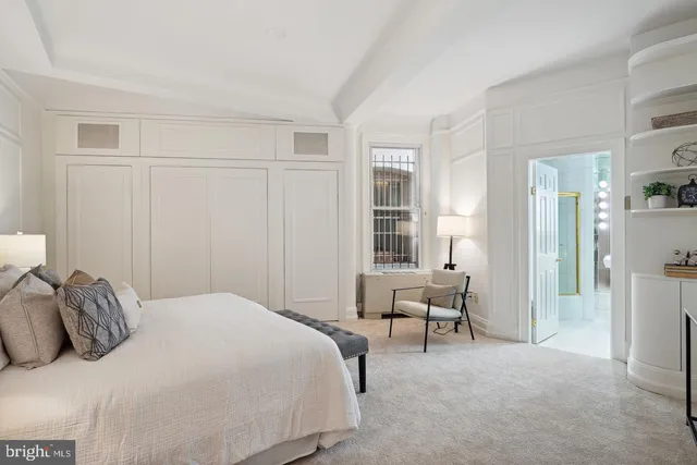 a bedroom with a bed and a chair