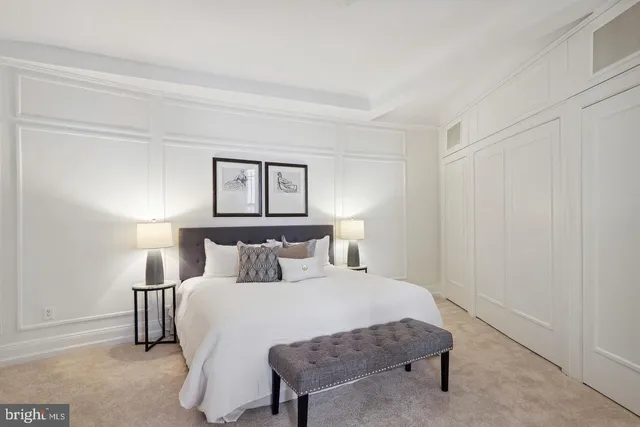 a bedroom with a bed and a night stand