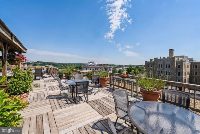 a view of a roof deck with furniture