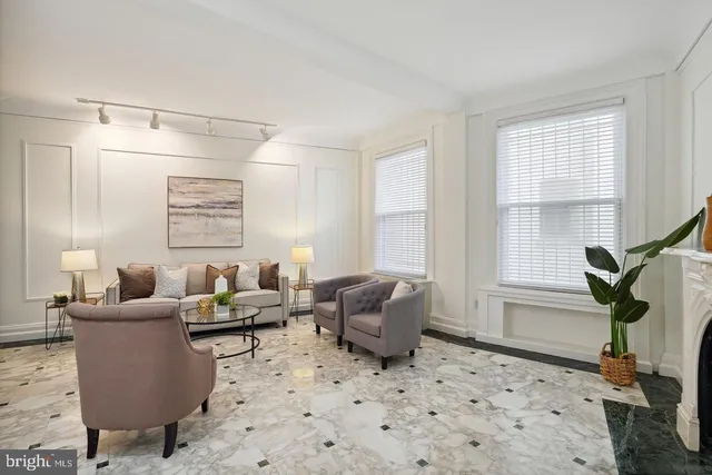 a living room with furniture windows and a table