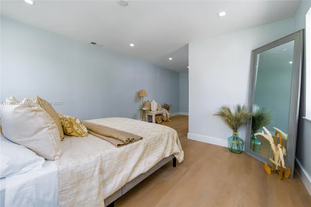 a bedroom with a bed and hallway