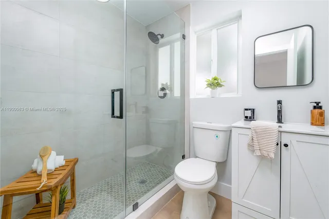 a bathroom with a toilet sink and shower
