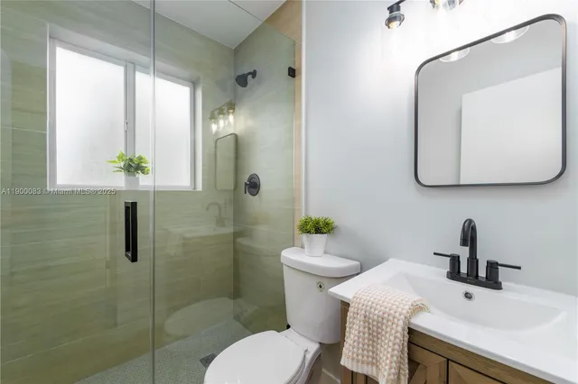 a bathroom with a toilet sink and mirror