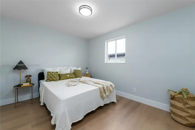 a bed sitting in a bedroom next to a window