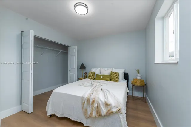 a bedroom with a bed and window