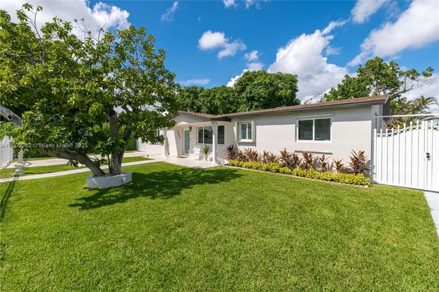 a front view of house with yard and green space