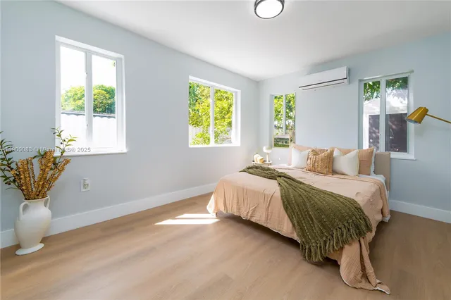 a bedroom with a bed and window