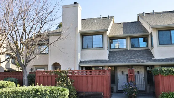 a front view of a house with barbeque and outdoor seating