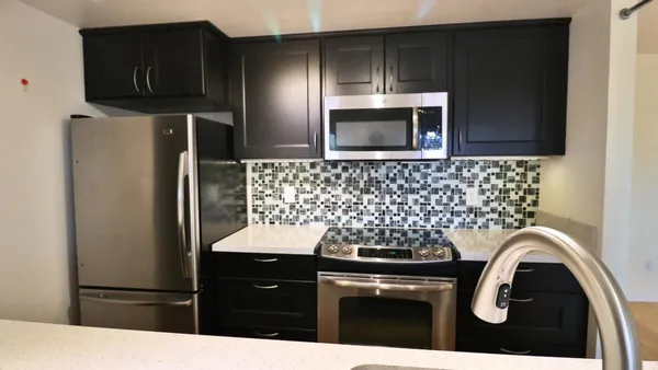 a kitchen with a refrigerator and a stove
