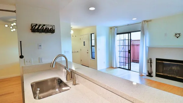 a kitchen with a faucet a fireplace and a sink