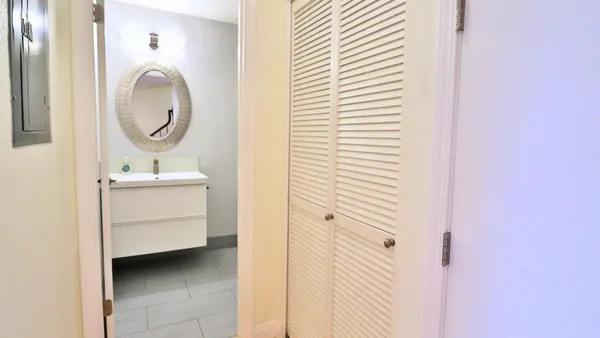 a bathroom with a sink a mirror and a vanity