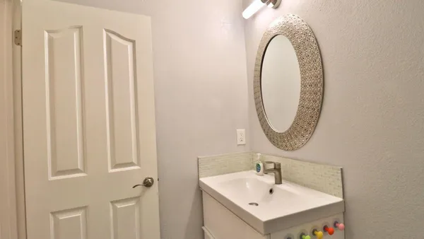 a bathroom with a sink and a mirror