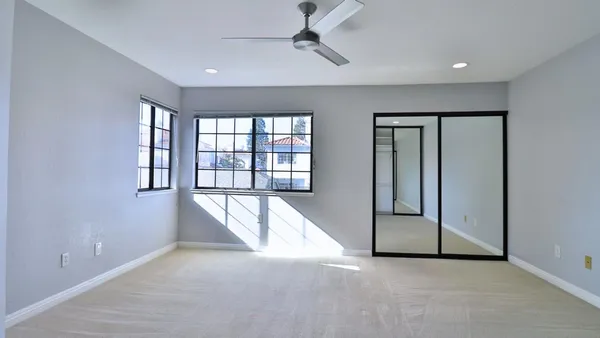 an empty room with windows and closet