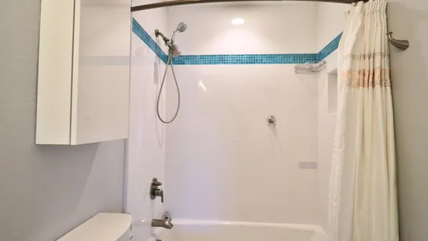 a bathroom with a shower and a mirror