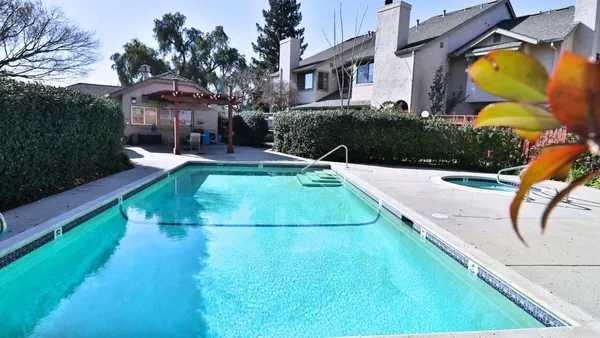 a view of a swimming pool with a patio
