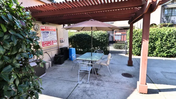 a patio with a patio table and chairs