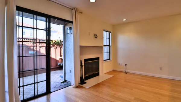 wooden floor fireplace and windows in an empty room
