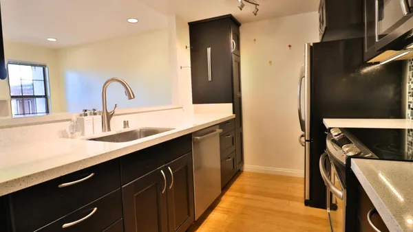 a kitchen with a sink and a refrigerator