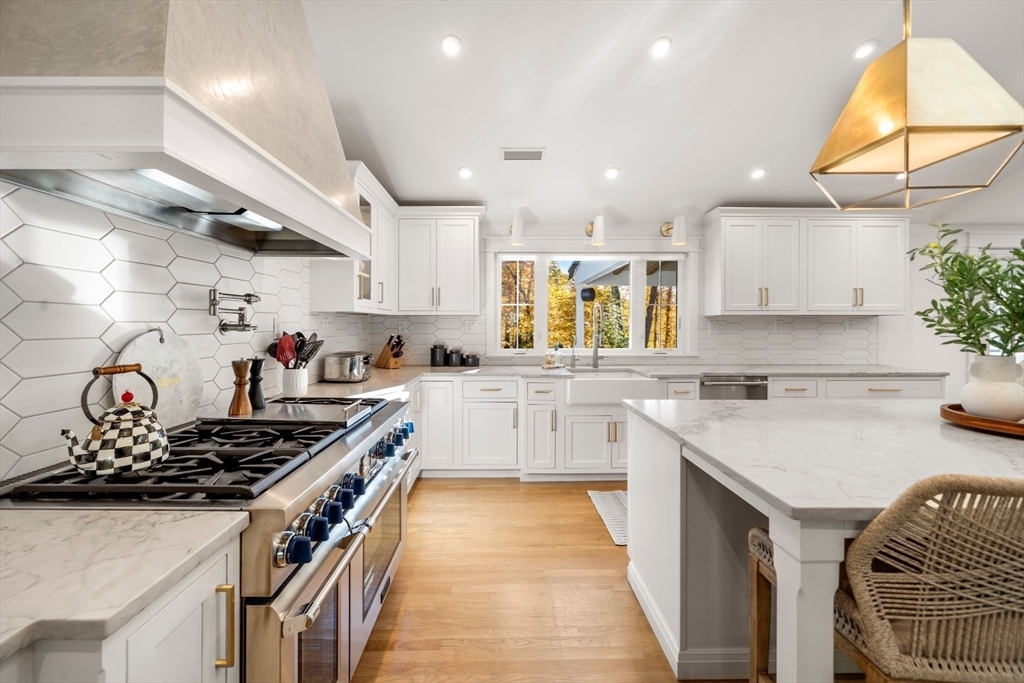 23 Tophet Road Lynnfield, MA 01940 - Photo 13 of 42 a kitchen with stainless steel appliances granite countertop a sink stove and cabinets