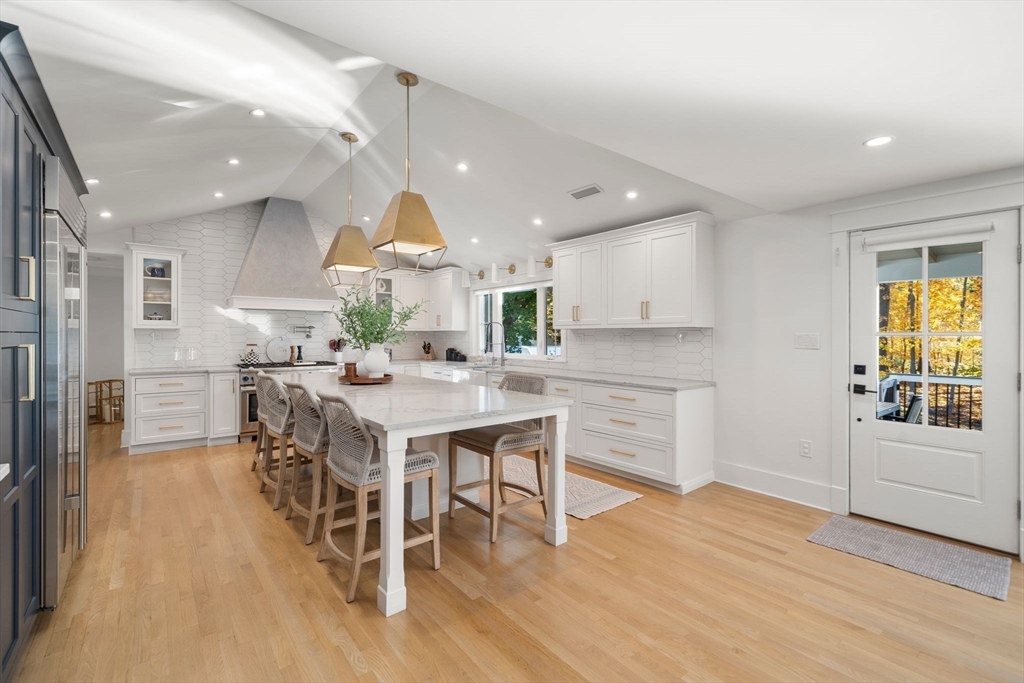 23 Tophet Road Lynnfield, MA 01940 - Photo 14 of 42 a kitchen with a table chairs wooden floors and a view of living room