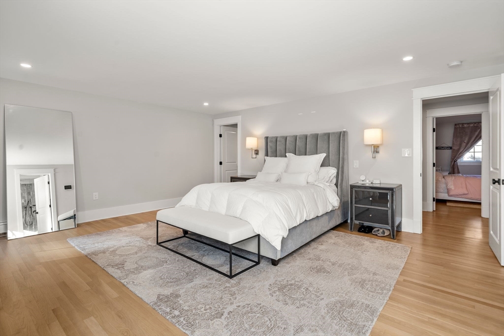 23 Tophet Road Lynnfield, MA 01940 - Photo 21 of 42 a spacious bedroom with a bed and wooden floor