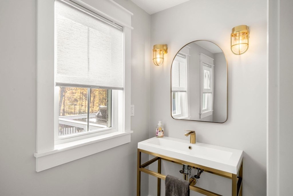 23 Tophet Road Lynnfield, MA 01940 - Photo 36 of 42 a bathroom with a sink a mirror and a window