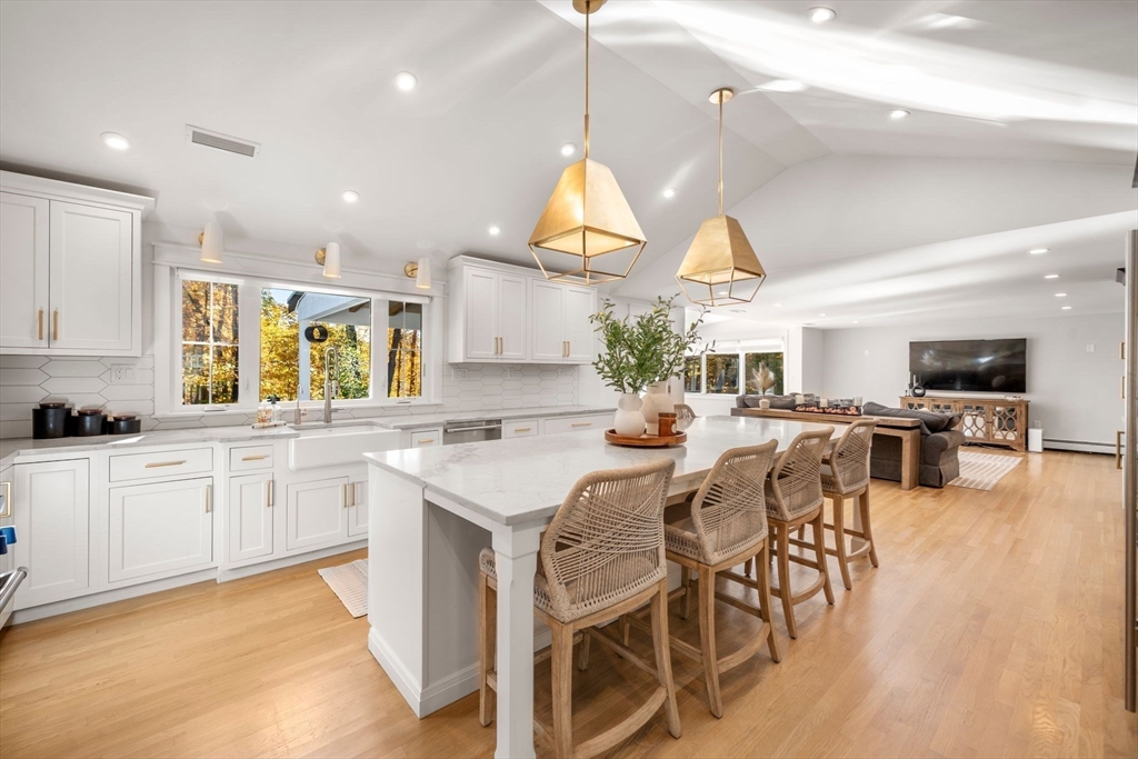 23 Tophet Road Lynnfield, MA 01940 - Photo 9 of 42 a kitchen with stainless steel appliances granite countertop lots of white cabinets appliances and a dining table