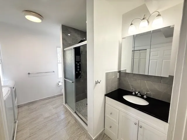 a bathroom with a sink toilet and shower