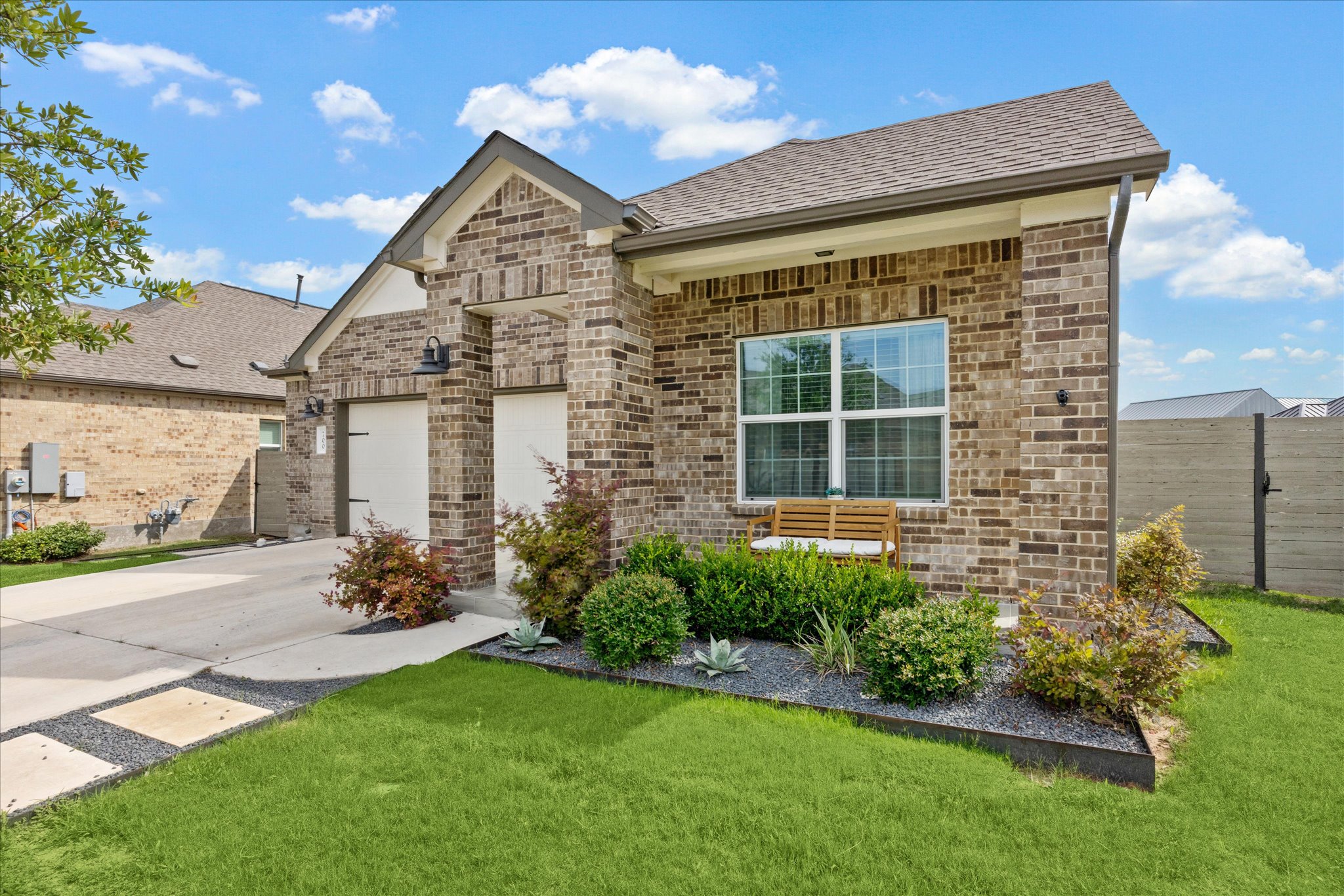 700 Legends Lane Georgetown, TX 78628 - Photo 3 of 31 View of front of home with driveway, brick siding, a garage, and a shingled roof