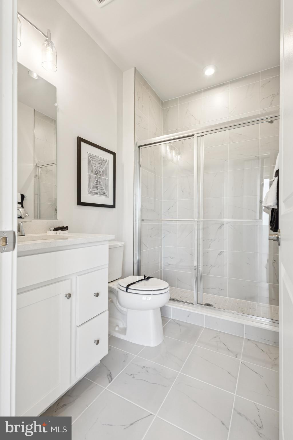 13712 Cobble Loop Woodbridge, VA 22193 - Photo 5 of 28 a bathroom with a toilet sink and a mirror