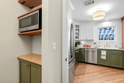 a kitchen with stainless steel appliances granite countertop a stove and a sink