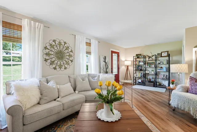 a living room with furniture and a large window