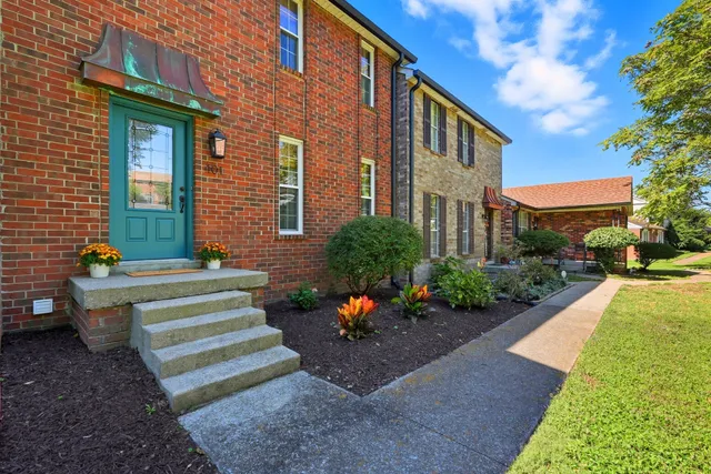 a view of a house with a yard and a garden