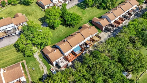 an aerial view of house with yard swimming pool and outdoor seating