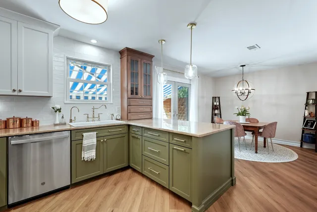 a kitchen with sink and cabinets