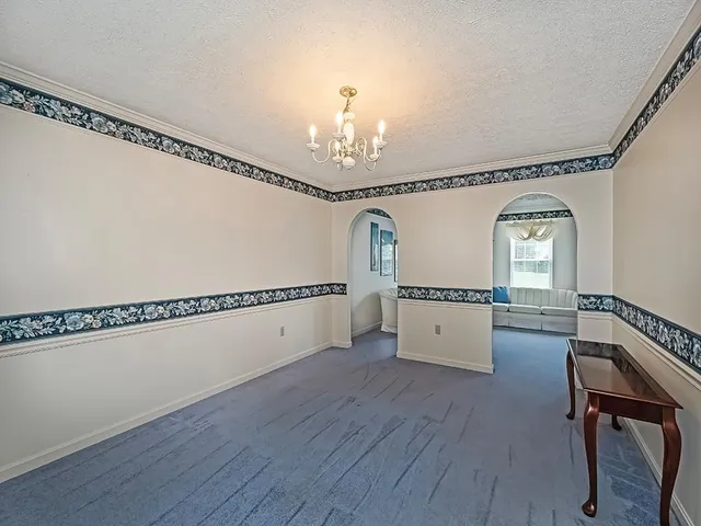 a view of a hallway with entryway wooden floor and front door