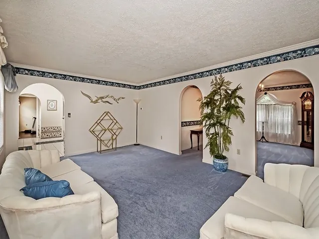 a living room with furniture and a rug