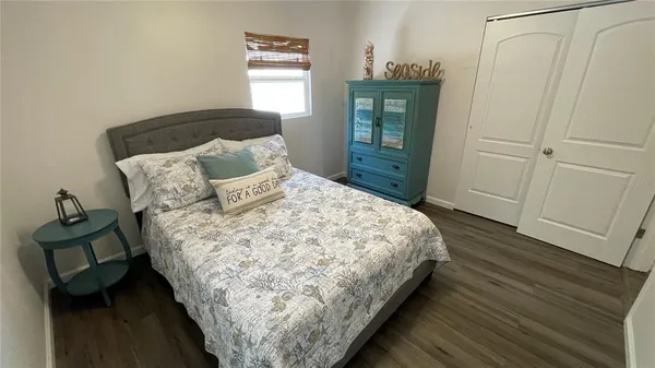 a large bed sitting in a bedroom next to a window