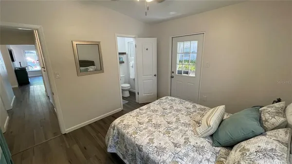 a bedroom with a bed and a mirror