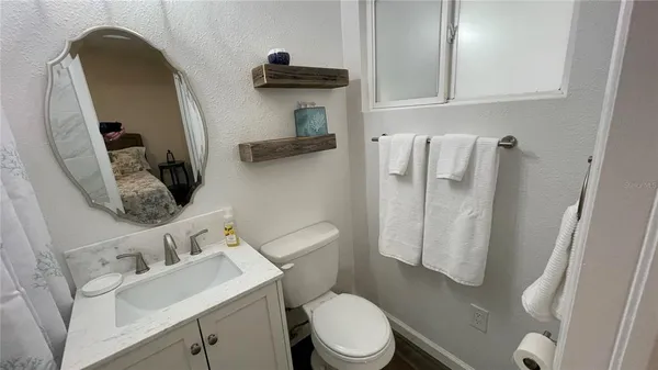 a bathroom with a sink a toilet and shower curtain