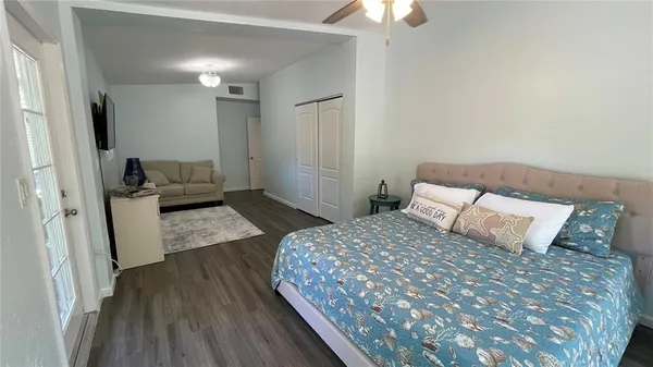 a bedroom with a bed and a couch